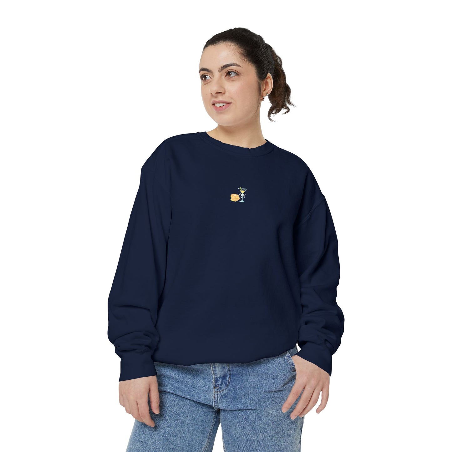 Woman wearing navy blue Hanukkah sweatshirt featuring embroidered stack of latkes and martini design at center chest