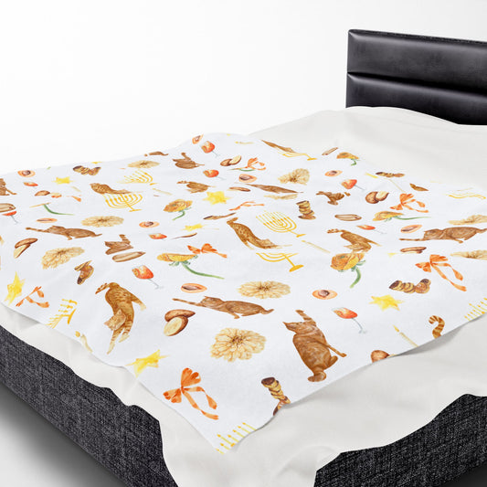 Throw blanket with Hanukkah pattern on bed