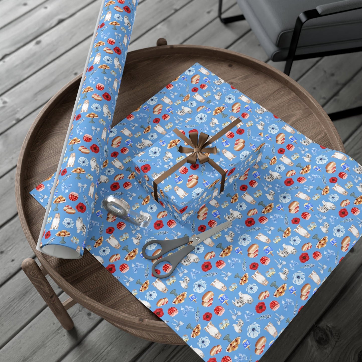 Roll of Hanukkah wrapping paper in vibrant blue pattern with tape and scissors