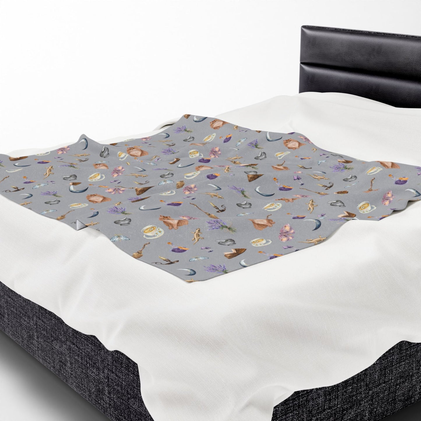 silver throw blanket in witchy aesthetic pattern on a bed