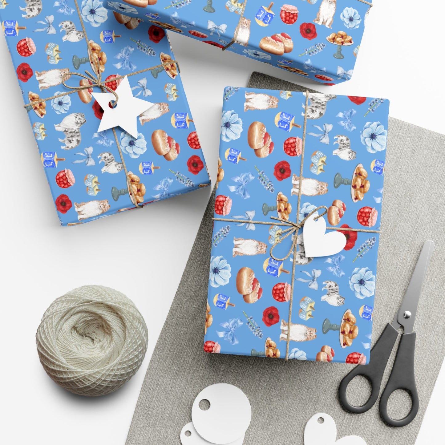Gift boxes wrapped in blue Hanukkah paper with colorful patterns, tied with string