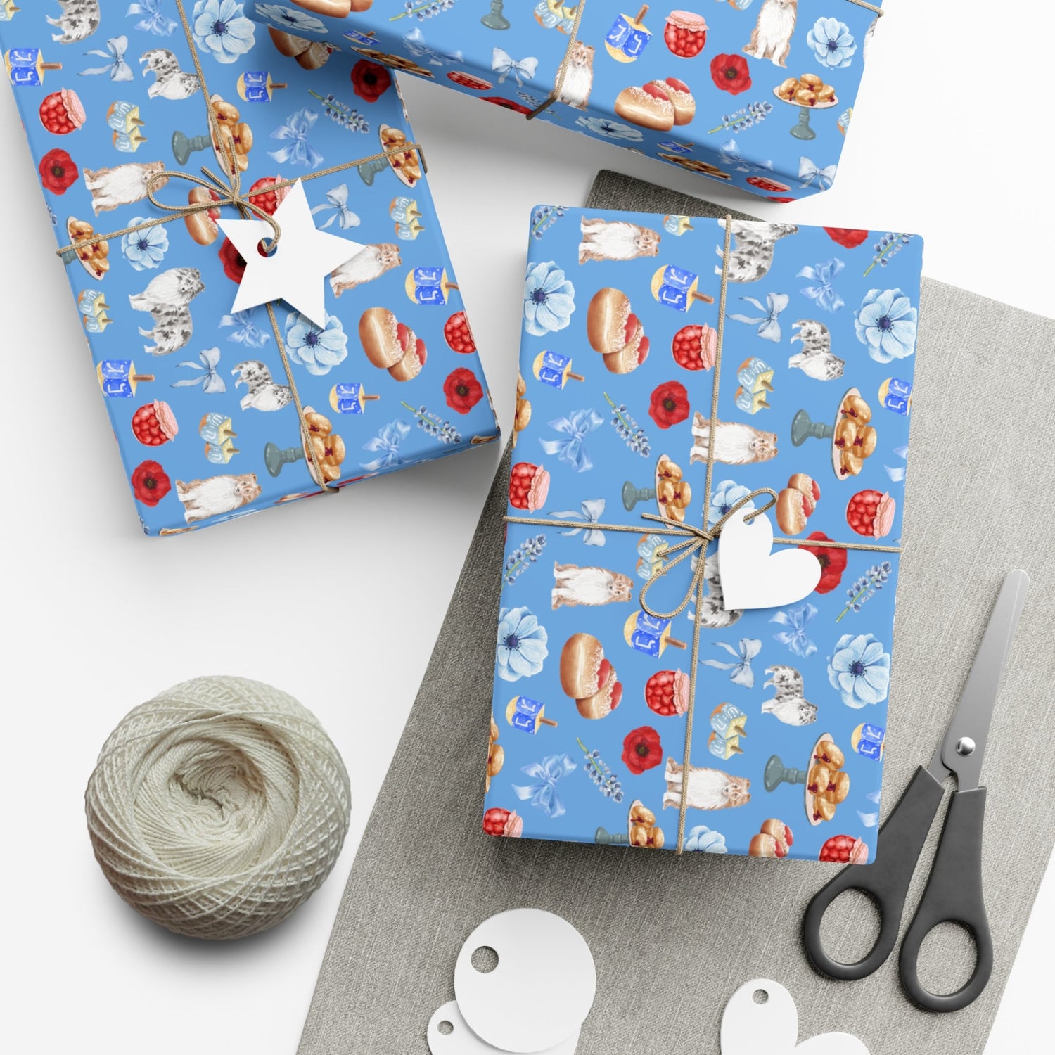 hanukkah gift wrapped in paper featuring dog design of shetland sheepdogs and sufganiyot