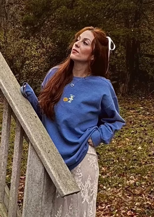 redhead woman wearing a trendy blue Hanukkah crewneck sweatshirt