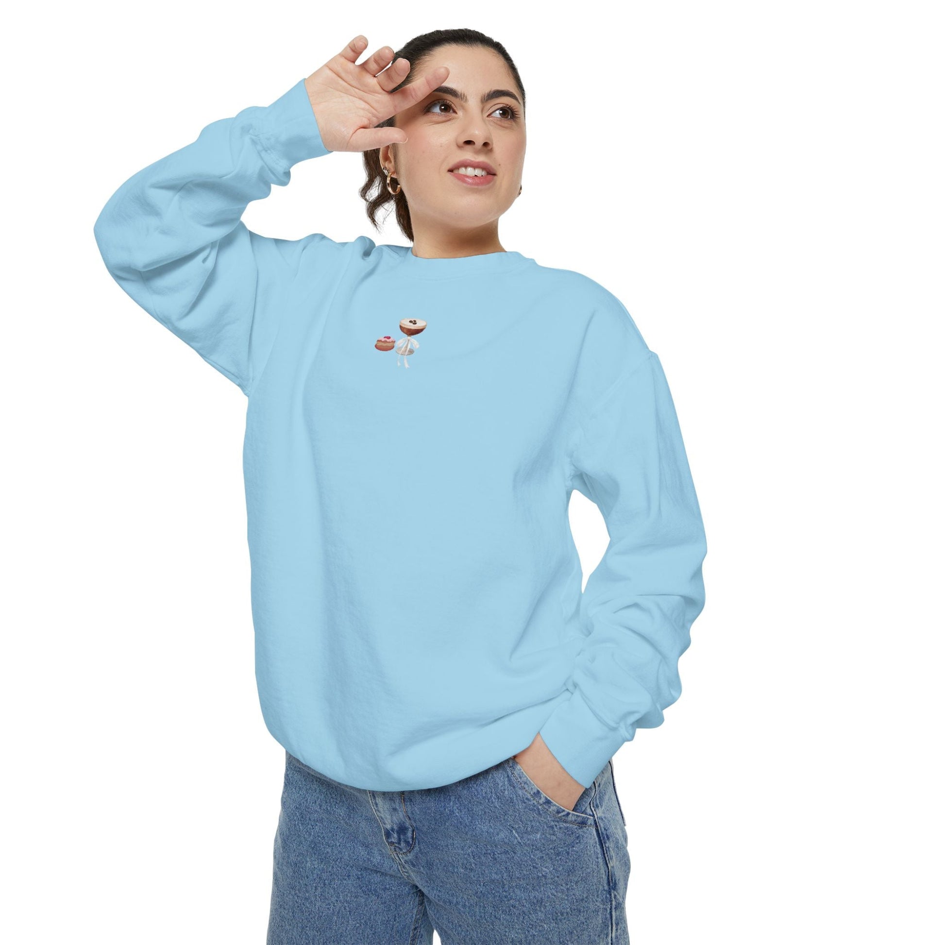 Woman wearing a light blue sweatshirt with a small embroidered Hanukkah design