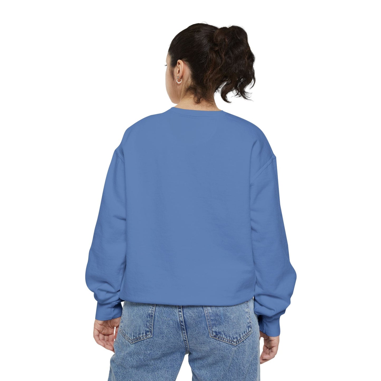 Back view of a woman wearing a blue Hanukkah sweatshirt and jeans