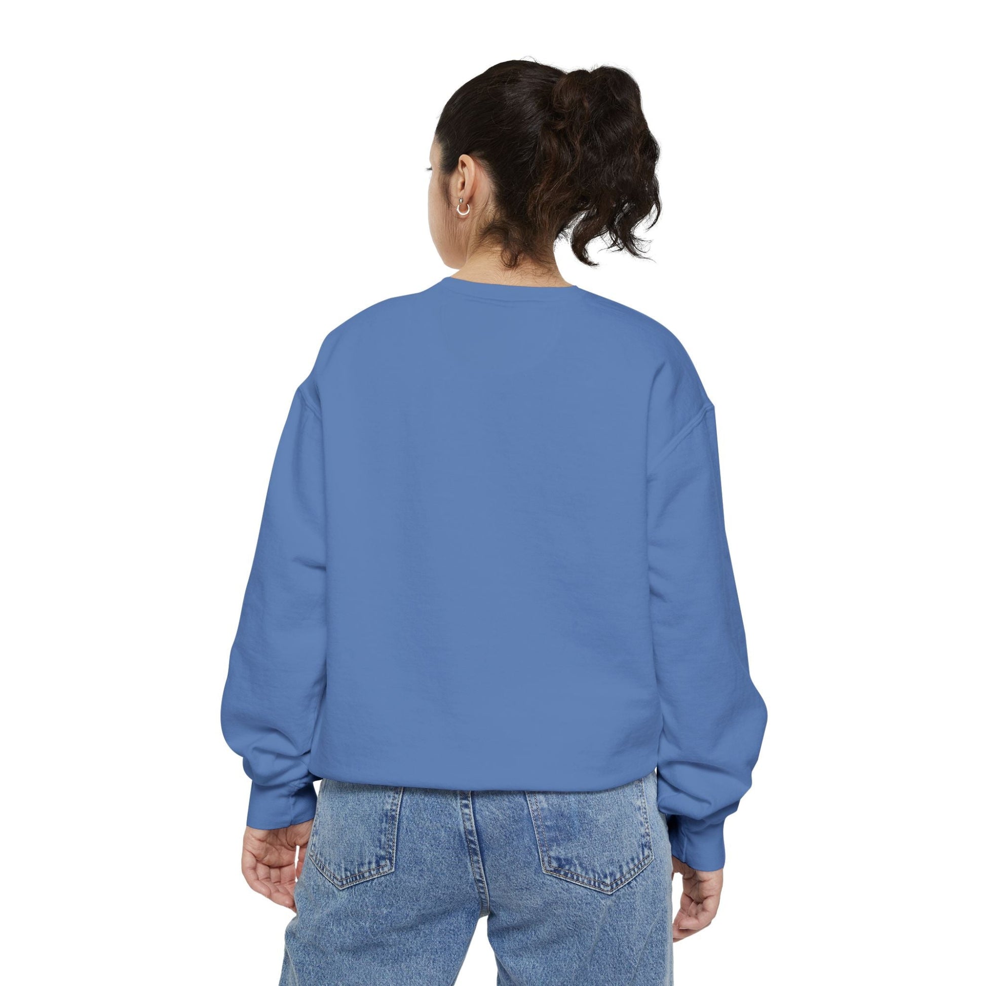 Back view of a woman wearing a blue Hanukkah sweatshirt and jeans