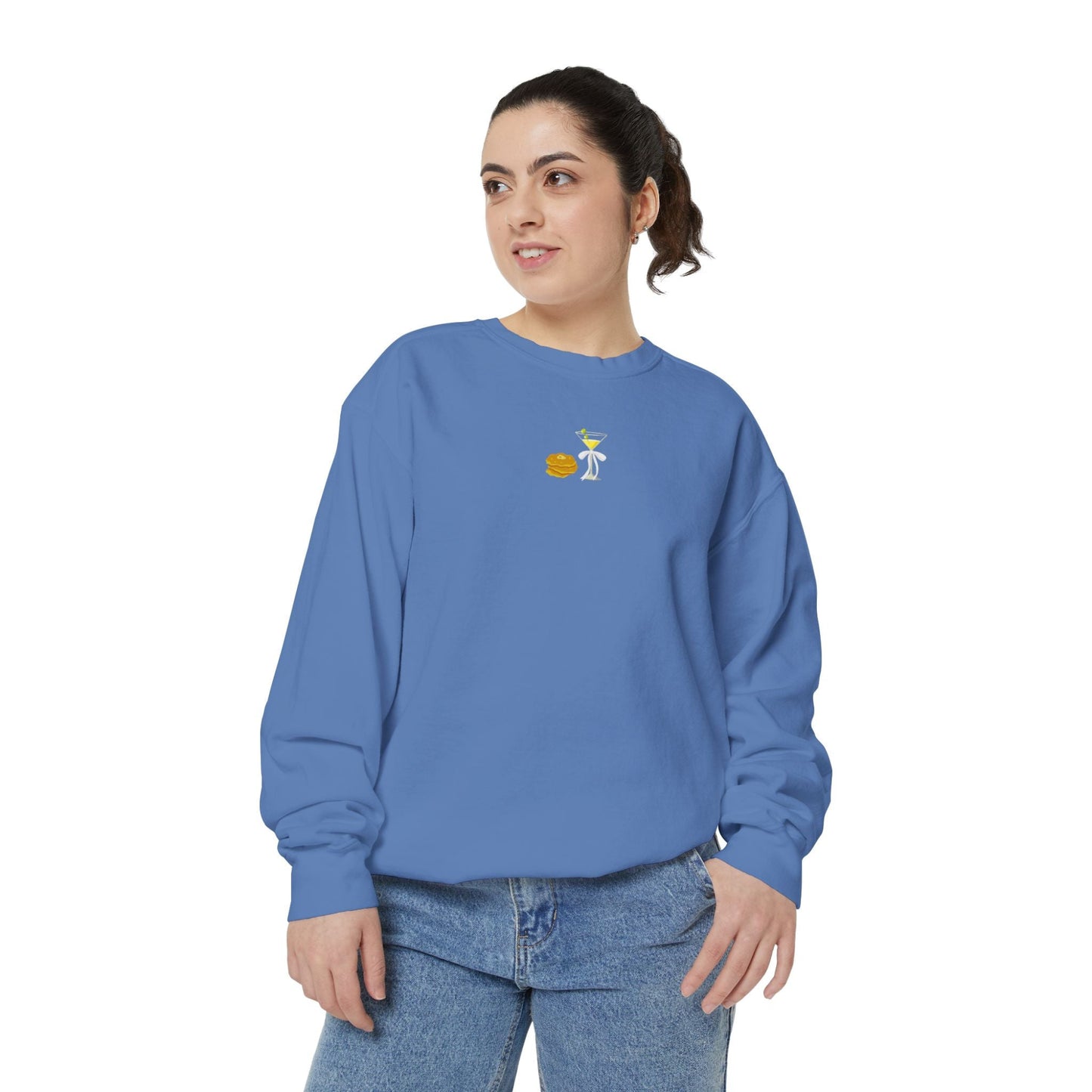 Woman wearing a blue sweatshirt with a small embroidered Hanukkah design and jeans
