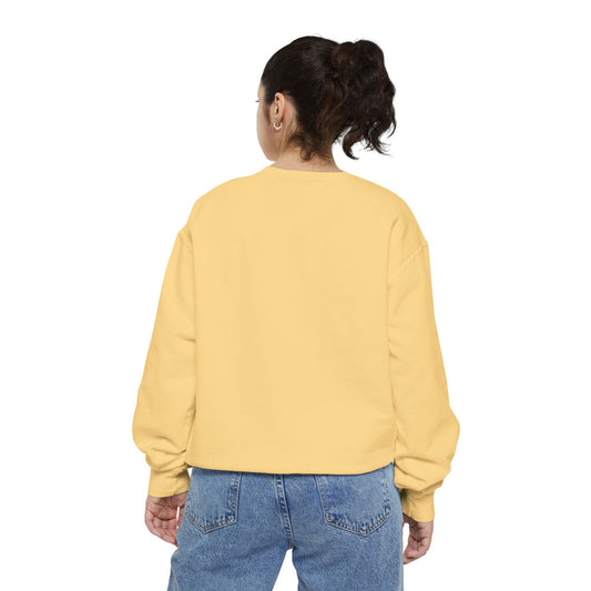 Back view of a woman wearing a yellow Hanukkah sweatshirt and jeans