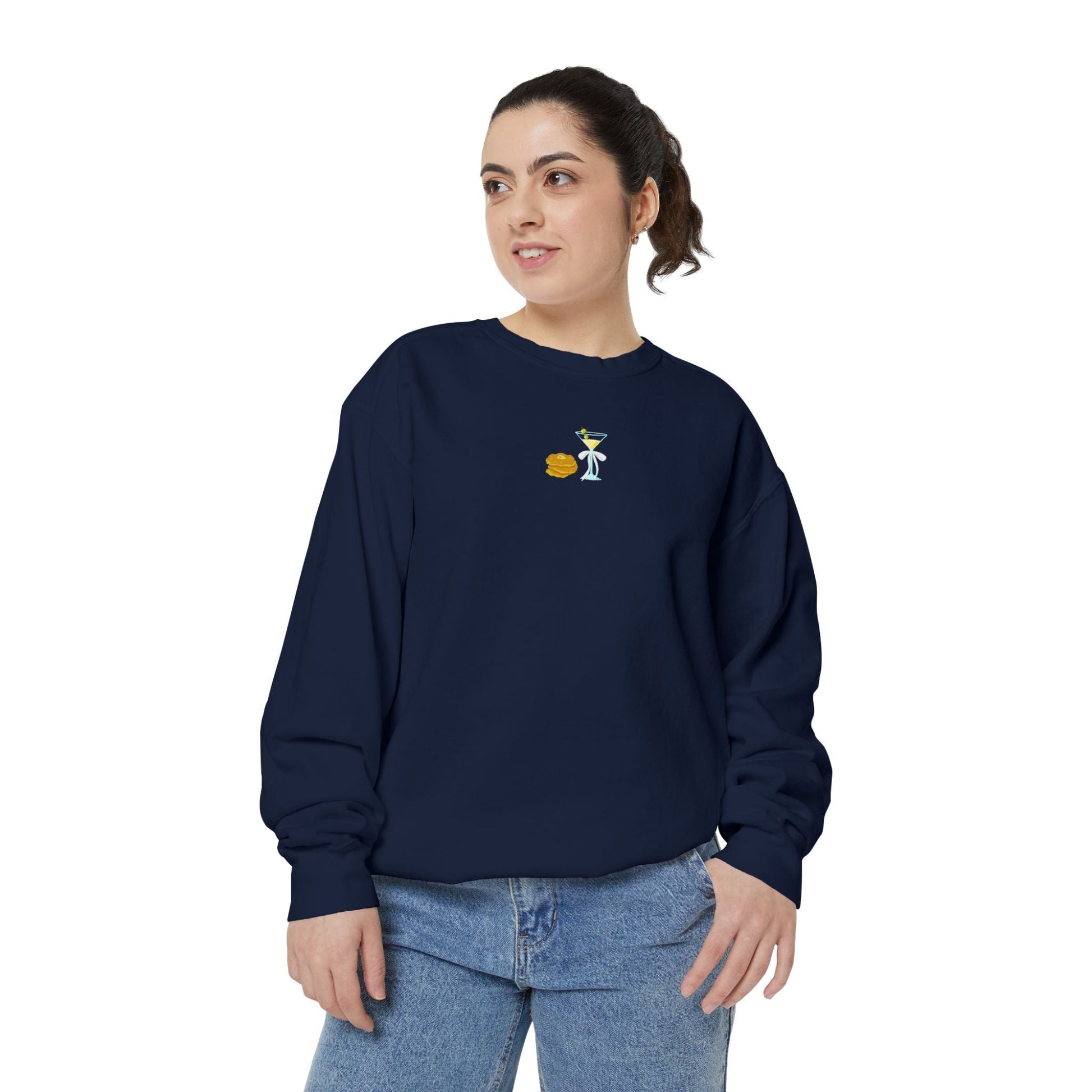 Woman wearing a navy blue sweatshirt with a small embroidered Hanukkah design