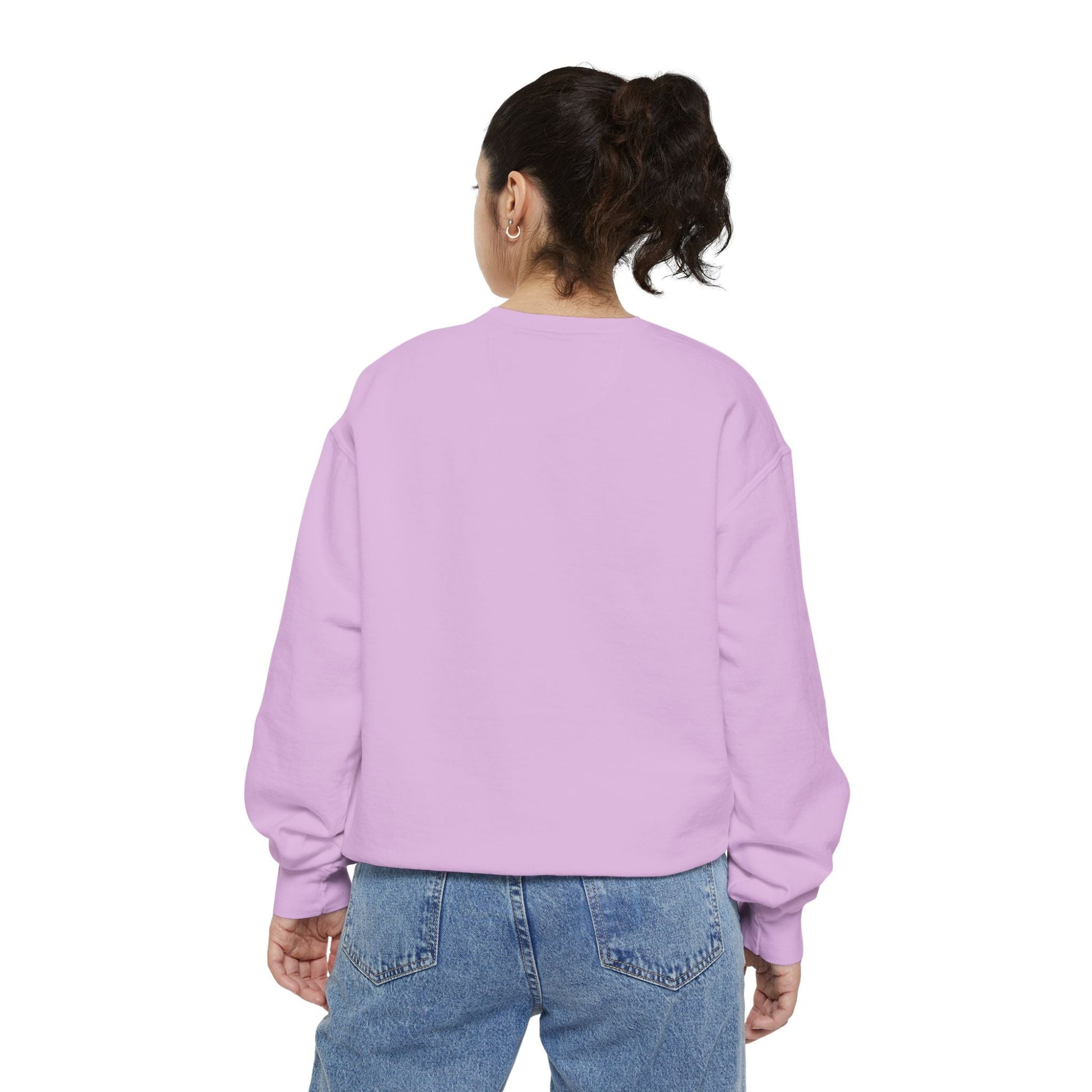 Back view of a woman wearing a light purple sweatshirt and blue jeans