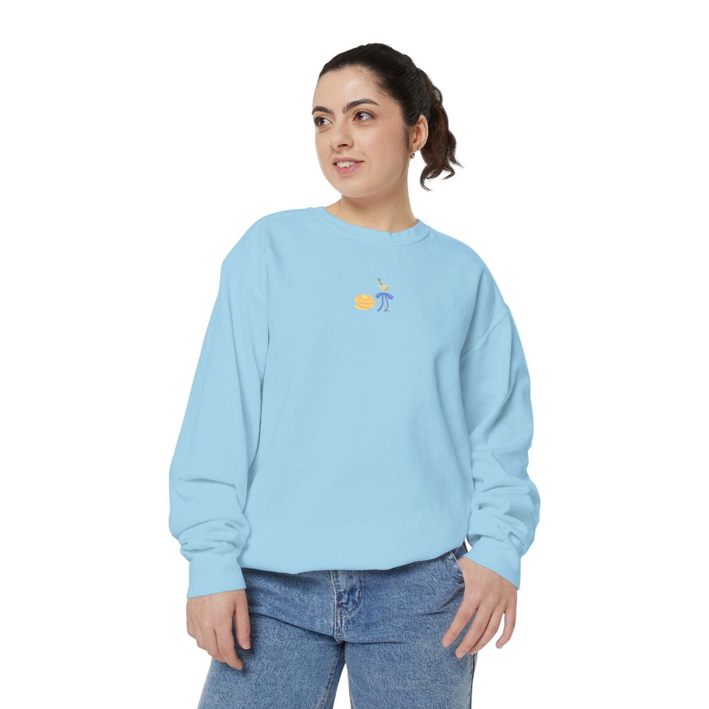 Woman wearing a light blue sweatshirt with a small embroidered Hanukkah design and jeans
