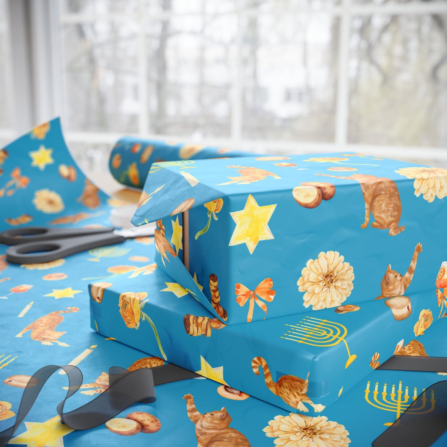 Wrapping Hanukkah presents in whimsical gift wrap with orange cats and golden menorahs
