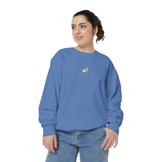 Woman wearing an earthy blue Hanukkah sweatshirt featuring embroidered latkes and martini