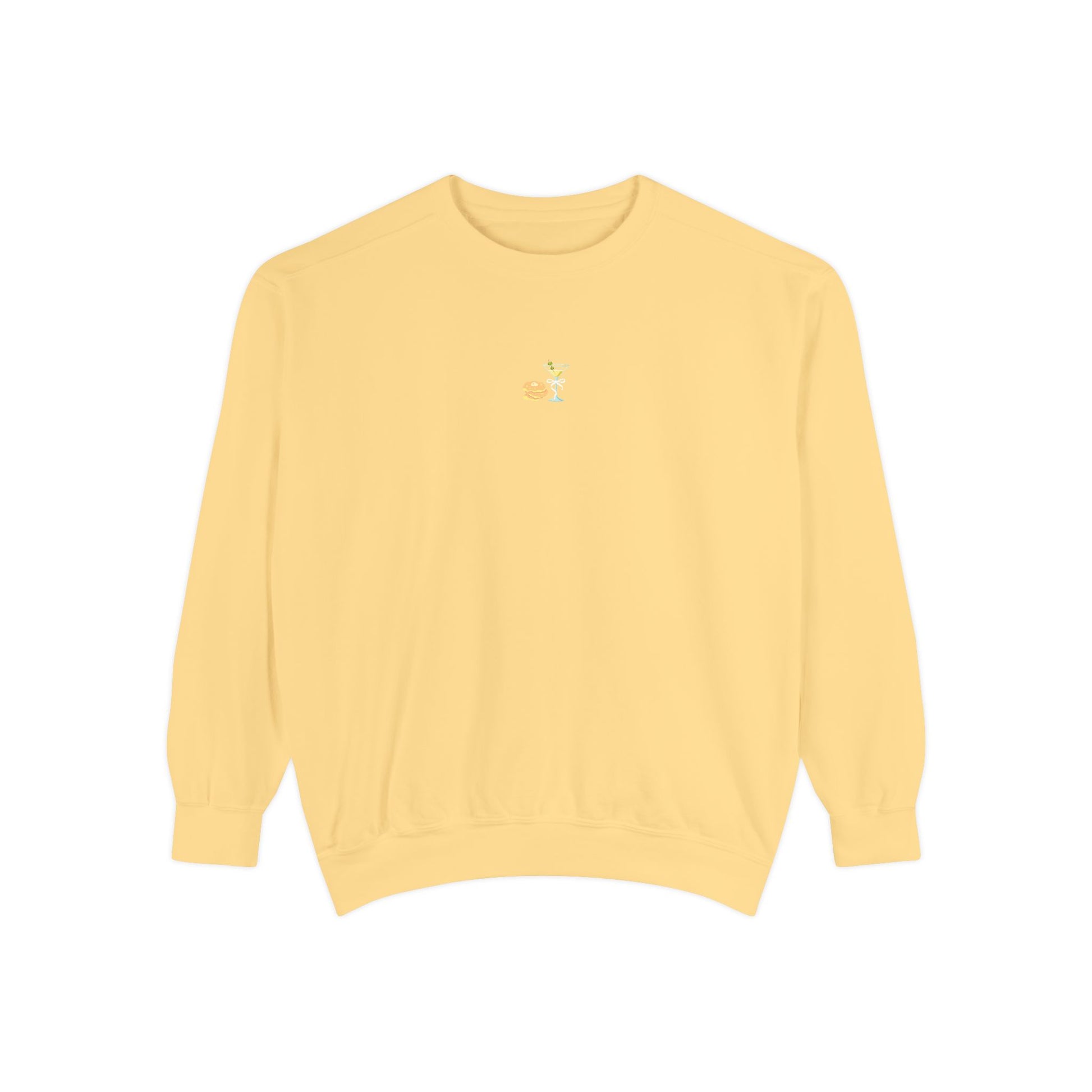 Butter yellow sweatshirt with small embroidered stack of latkes and martini design at center chest