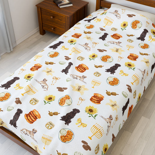 Large throw blanket with Hanukkah-themed pattern featuring dogs, latkes, and sunflowers on a twin bed