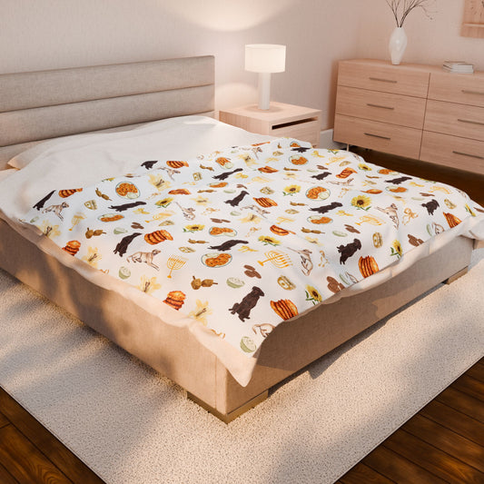 Queen bed with a colorful patterned throw blanket in a bedroom setting