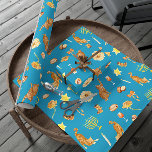 Roll of blue Hanukkah-themed wrapping paper with a box and scissors on a wooden surface.